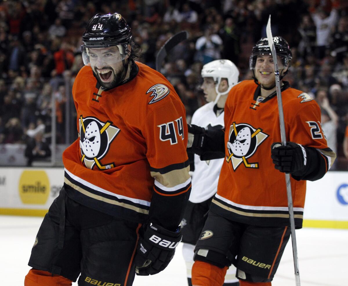 The Ducks' Nate Thompson, left, and Mike Santorelli exult after teammate Chris Stewart's decisive goal against the Pittsburgh Penguins during the second period.