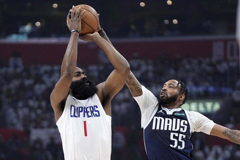 Los Angeles Clippers guard James Harden, left, shoots as Dallas Mavericks forward Derrick Jones Jr. defends during the first half in Game 5 of an NBA basketball first-round playoff series Wednesday, May 1, 2024, in Los Angeles. (AP Photo/Mark J. Terrill)
