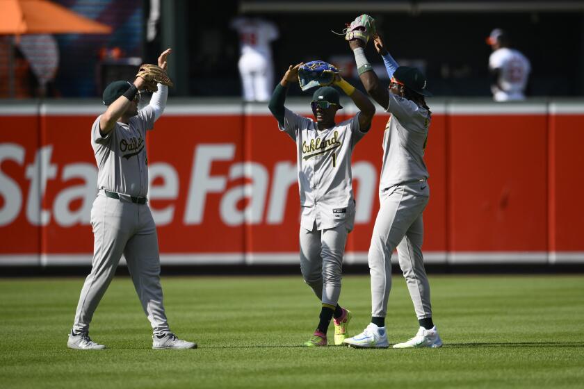 From left to right, Oakland Athletics' Seth Brown, Esteury Ruiz and Lawrence Butler celebrate after a baseball game against the Baltimore Orioles, Sunday, April 28, 2024, in Baltimore. (AP Photo/Nick Wass)