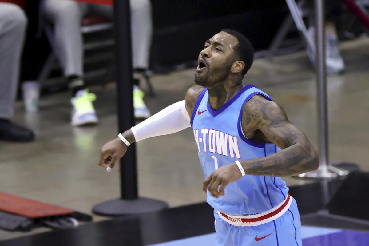 Houston Rockets' John Wall reacts during the second quarter against the Washington Wizards.