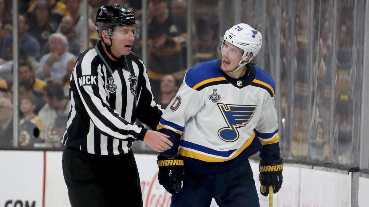 St. Louis Blues' Oskar Sundqvist is escorted to the penalty box after being called for a cross-checking penalty against the Boston Bruins during the second period in the Stanley Cup Final.