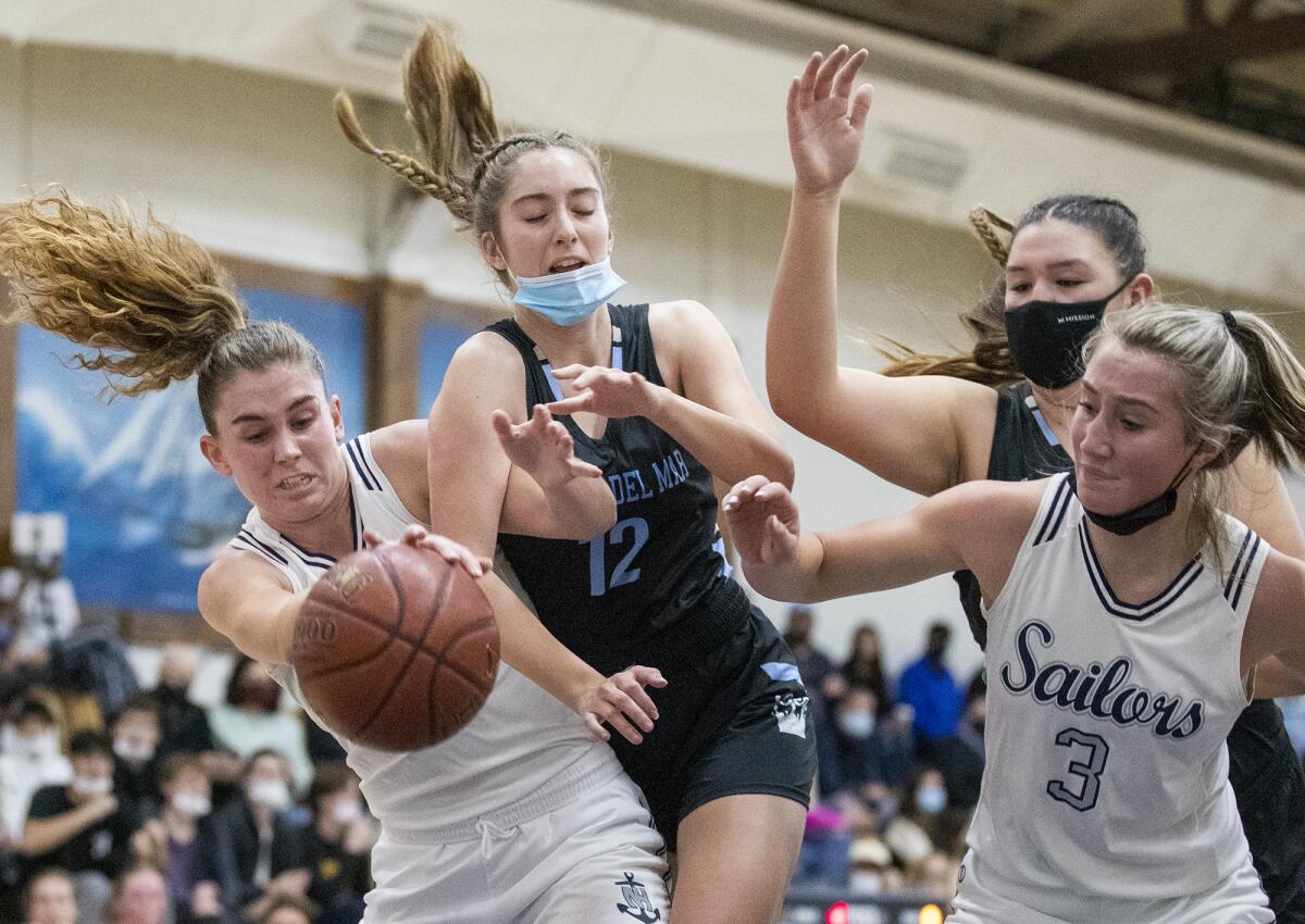 Newport Harbor's Emma Fults, left, and Kate Bland go for a rebound against CdM's Sarah Audiss, center and Makena Tomlinson.