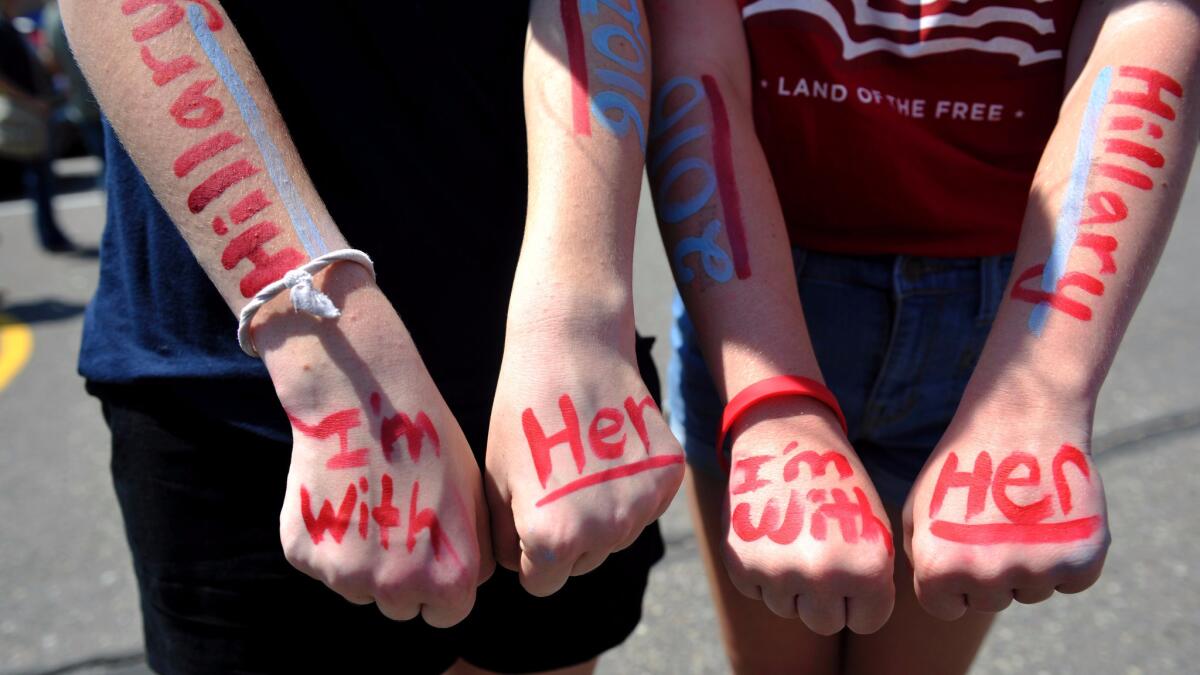 Two girls in Commerce City, Colo., show their support for Hillary Clinton in August.