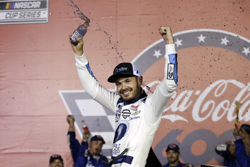 NASCAR Cup Series driver Kyle Larson celebrates in victory lane after winning the NASCAR Cup Series auto race at Charlotte Motor Speedway in Concord, N.C., late Sunday, May 30, 2021. (AP Photo/Nell Redmond)