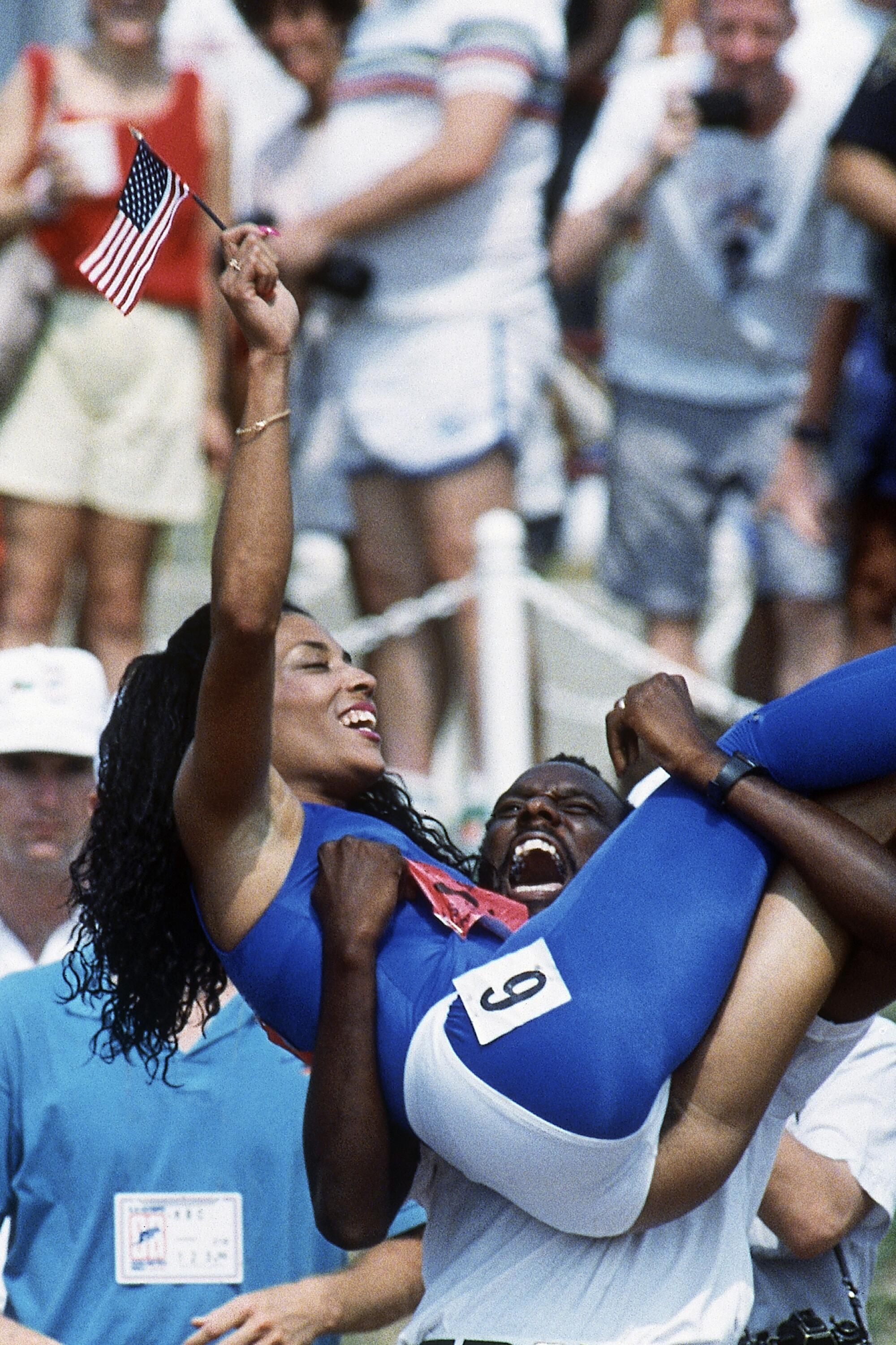 Bobby Kersee lifts Florence Griffith Joyner after her win in the women's 100 meters at the 1988 U.S. Olympic trials.