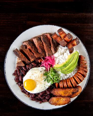 LONG BEACH, CA - JUNE 10: Bandeja paisa from Selva on Friday, June 10, 2022 in Long Beach, CA. Part of the brunch menu, the Bandeja paisa comes with flat iron, rice and beans, chicharron, sweet plantains, and chorizo. (Mariah Tauger / Los Angeles Times)