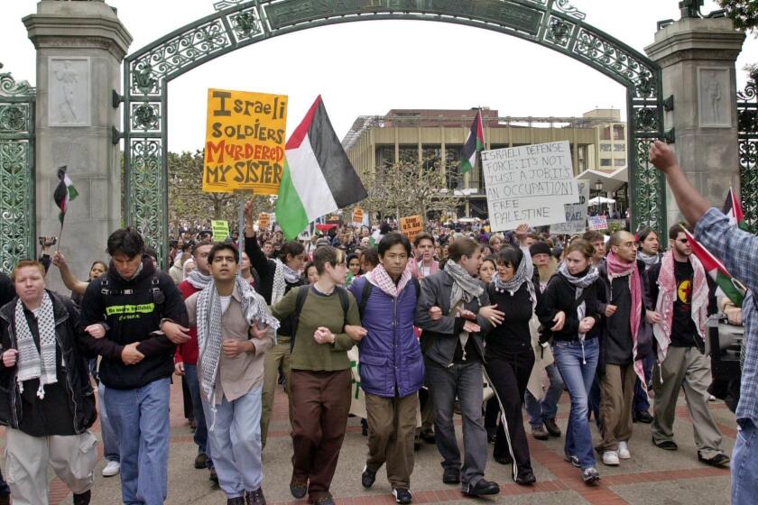 Pro?Palestinian demonstrators march through Sather Gate on the University of California, Berkeley campus, Tuesday, April 9, 2002. Jewish students held a rally at the same time on campus to remember victims of the Holocaust. (AP Photo/Paul Sakuma)