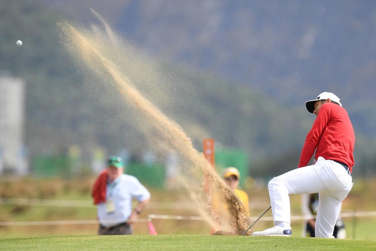 France's Julien Quesne plays a shot out of a bunker during the first round of the men's golf tournament at the Olympic Golf Course on Thursday.