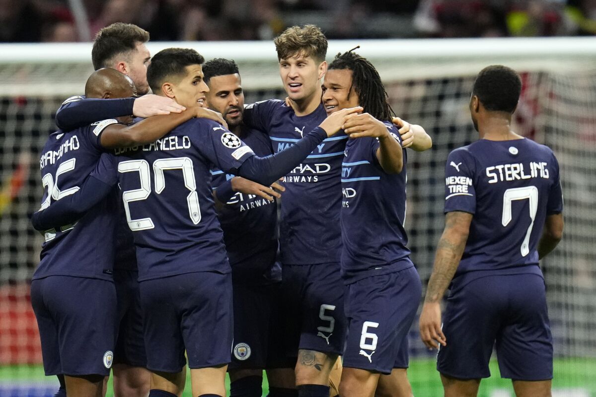 Manchester City's players celebrate after the Champions League quarterfinal second leg soccer match between Atletico Madrid and Manchester City at Wanda Metropolitano stadium in Madrid, Spain, Wednesday, April 13, 2022. (AP Photo/Manu Fernandez)