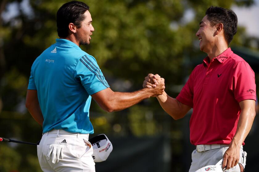 Jason Day, left, and Sang-Moon Bae congratulate each other Saturday after they finished the third round of the Barclays tied for the lead.