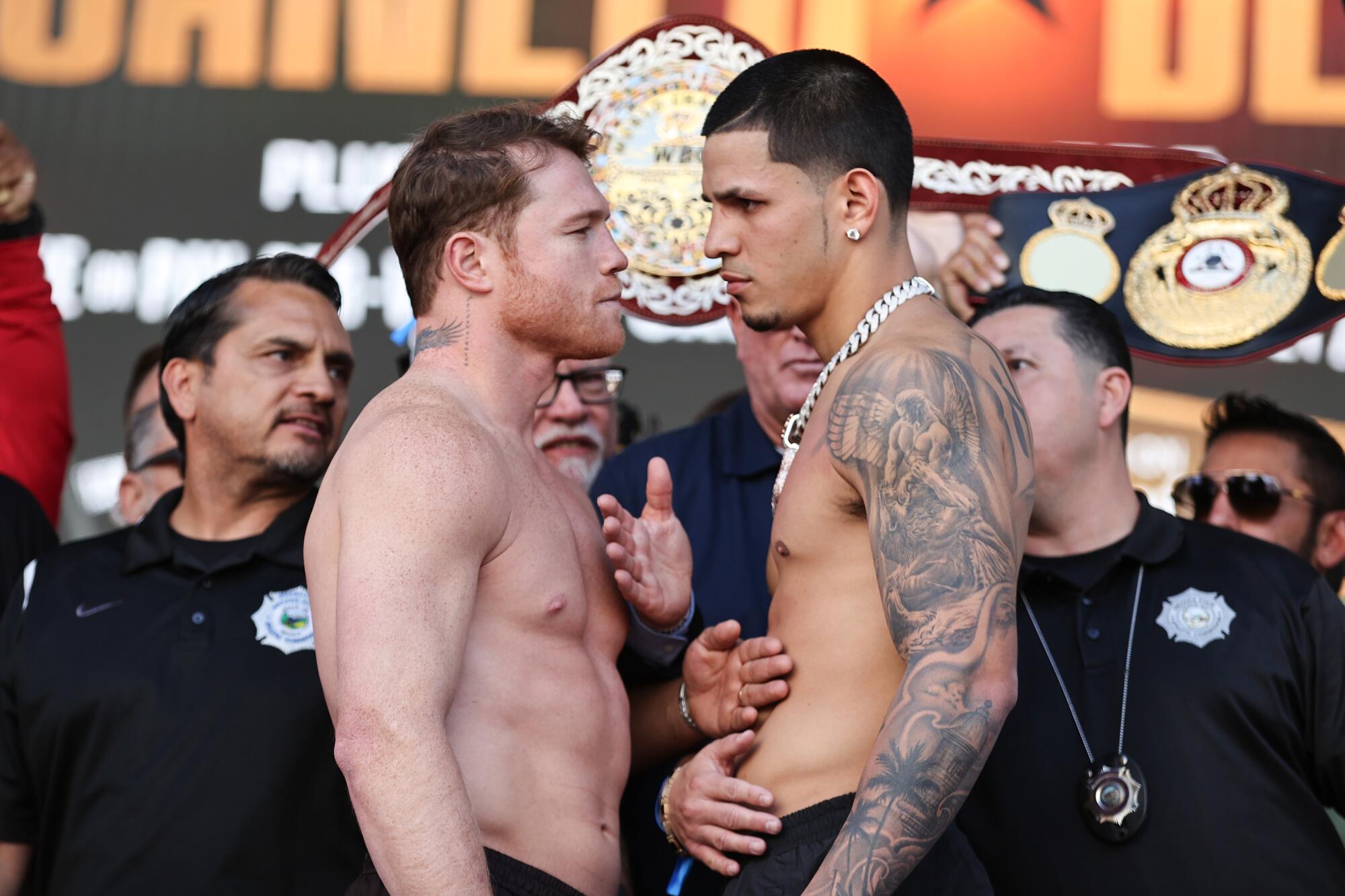 Canelo Álvarez, left, and Edgar Berlanga stare down one another during their weigh in at T-Mobile Arena in Las Vegas.