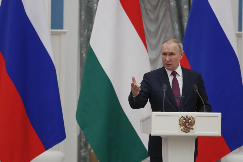 Russian President Vladimir Putin gestures while speaking to the media during a joint news conference with Hungary's Prime Minister Viktor Orban following their talks in the Kremlin in Moscow, Russia, Tuesday, Feb. 1, 2022. Putin says the U.S. and its allies have ignored Russia's top security demands. In his first comments on the standoff with the West over Ukraine in more than a month, Putin said Tuesday that the Kremlin is still studying the U.S. and NATO's response to the Russian security demands received last week. (Yuri Kochetkov/Pool Photo via AP)