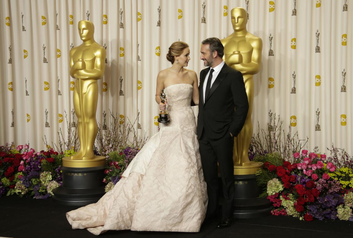 Jennifer Lawrence poses with actor Jean Dujardin after accepting her best-actress Oscar for "Silver Linings Playbook" in February 2013.