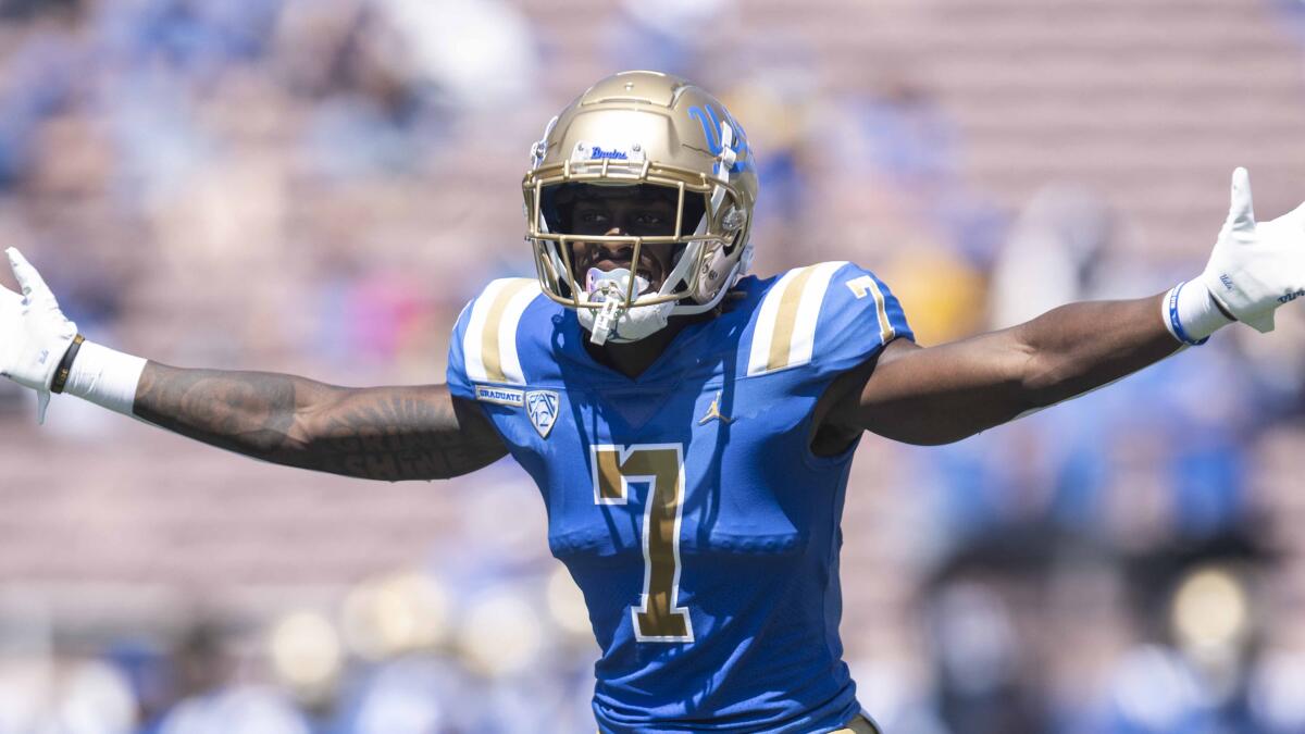 UCLA defensive back Mo Osling III holds his arms out by his sides while in a football uniform.