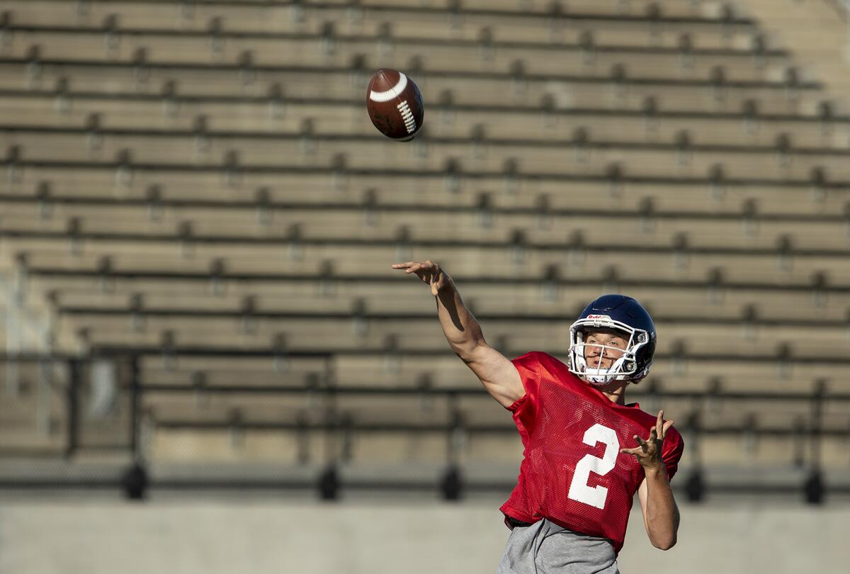 Cole Lavin, shown throwing a pass during practice on Wednesday, returns as Newport Harbor's starting quarterback.