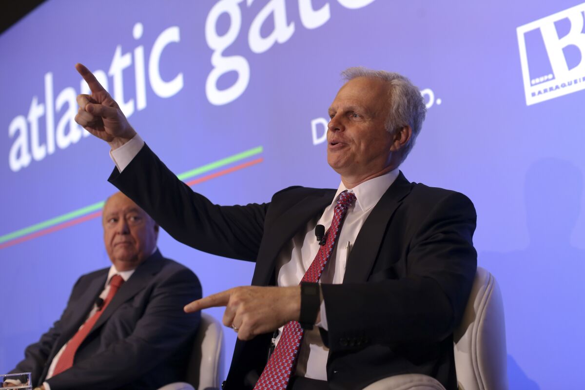 FILE - In this June 24, 2015 file photo, David Neeleman, right, talks to journalists during a joint news conference with his partner Portuguese businessman Humberto Pedrosa, in Lisbon. Less than a year after it started flying, new Breeze Airways is announcing an aggressive expansion plan that will include flights on the West Cost. Breeze said Tuesday, March 8, 2022, that it will add 35 routes from 10 more cities. (AP Photo/Francisco Seco, File)