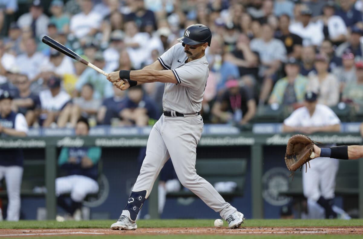 New York Yankees' Matt Carpenter fouls a ball off his foot against the Seattle Mariners during the first inning of a baseball game, Monday, Aug. 8, 2022, in Seattle. He left the game after his at bat. (AP Photo/John Froschauer)