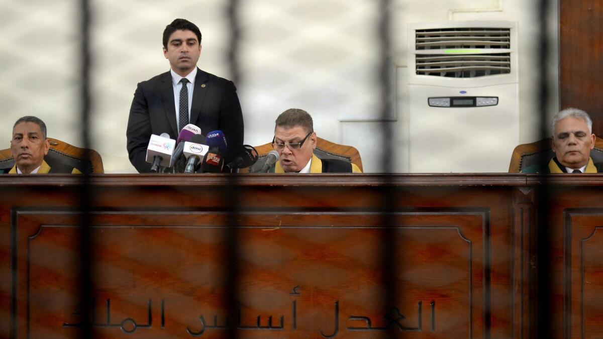 Egyptian judge Mohammed Fahmy, center, reads out the life sentence against Muslim Brotherhood businessman Hassan Malek (not seen in the picture) during the final session of his trial in Cairo on Tuesday.