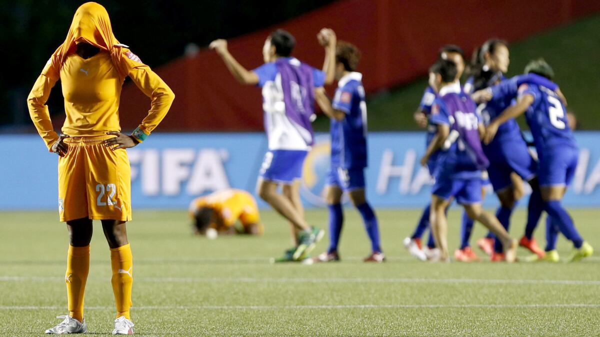 Ivory Coast's Cynthia Djohore reacts after losing to Thailand in a Group B game of the Women's World Cup on June 11. Ivory Coast had lost their opening game to Germany, 10-0, on June 8.