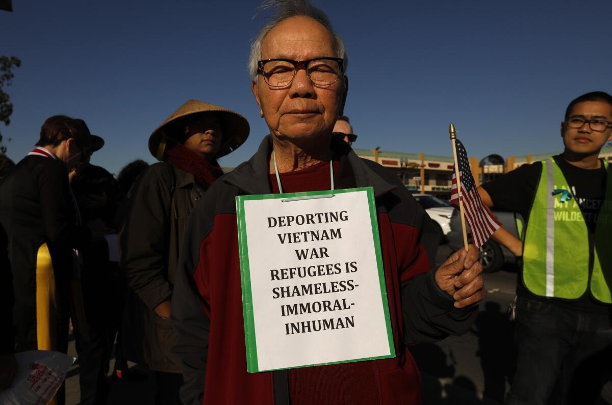 Lan Hoang, 85, center, joins members of the Little Saigon community who march and rally against the Trump administration's attempt to change the repatriation agreement between the US and Vietnam.