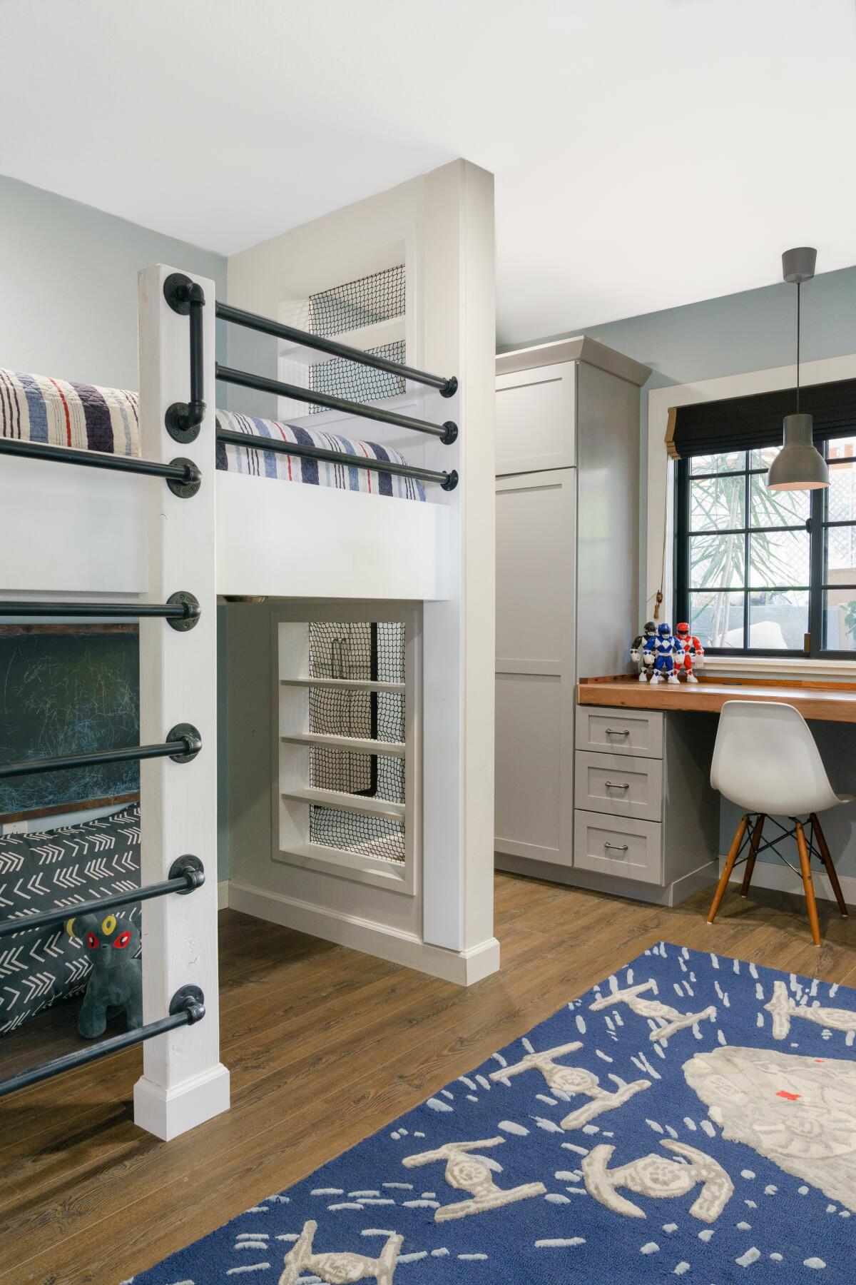 Built-ins provide storage in the "farmhouse luxe" boys room, with desk space adjacent.