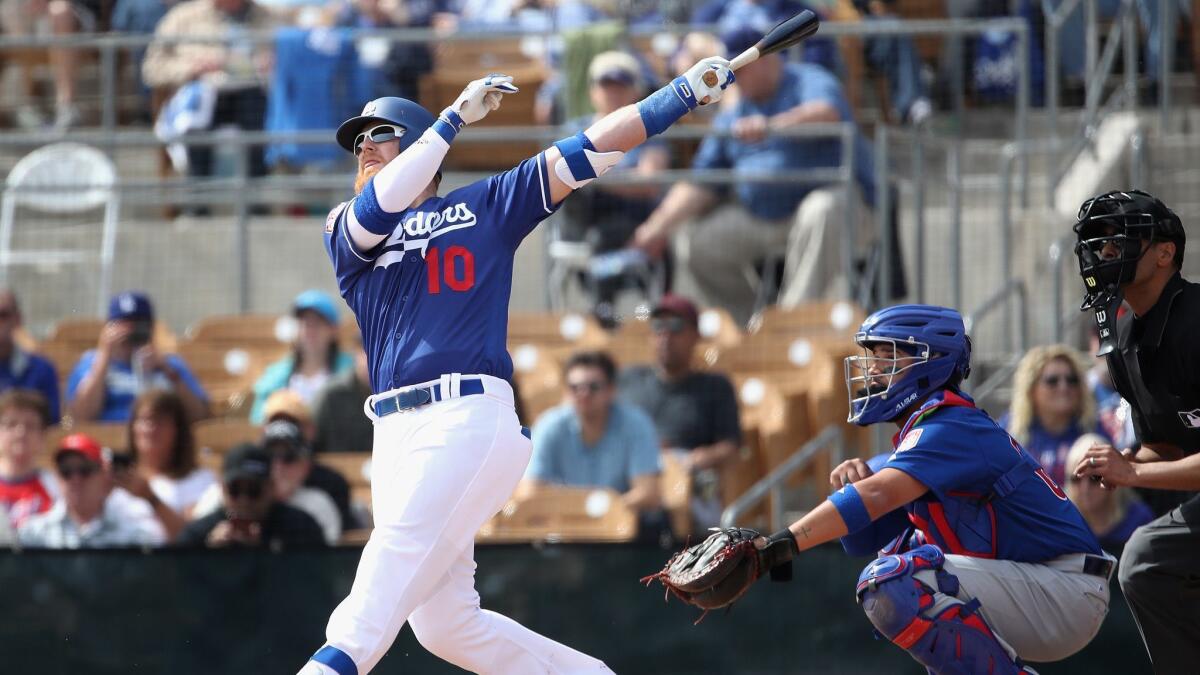 Justin Turner of the Dodgers hits a two-run homer against the Chicago Cubs in the first inning Monday.