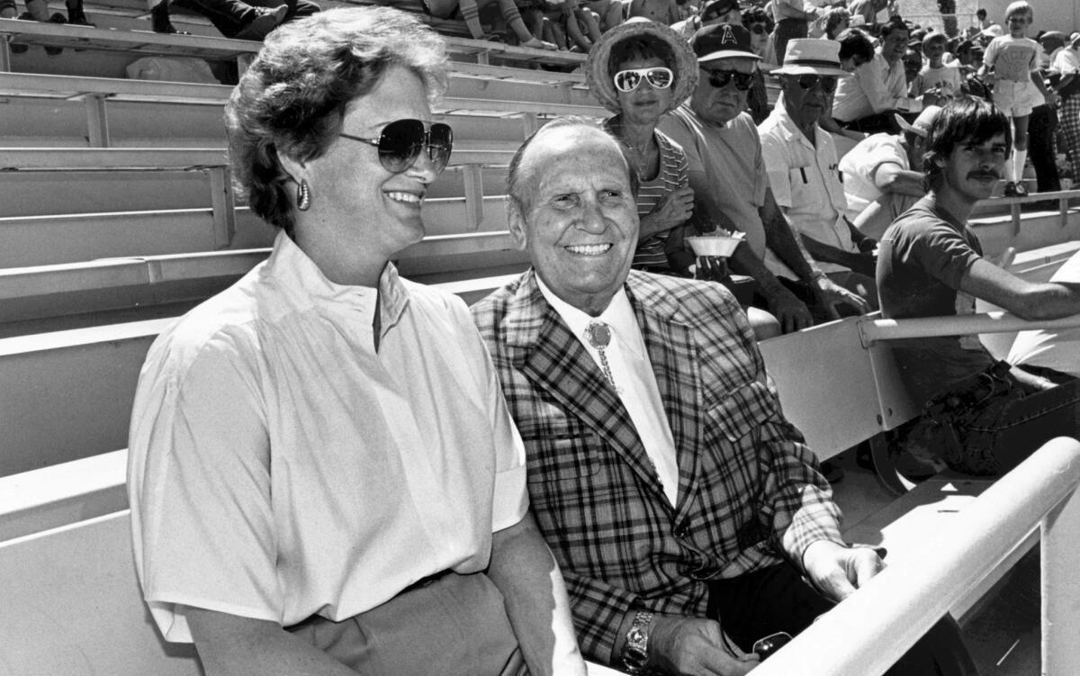 March 1984: Gene Autry takes his place in the owner's box alongside his wife, Jackie, executive vice president of the team, at Angels Stadium in Palm Springs, but he prefers to sit near the action – in a chair just behind the dugout.