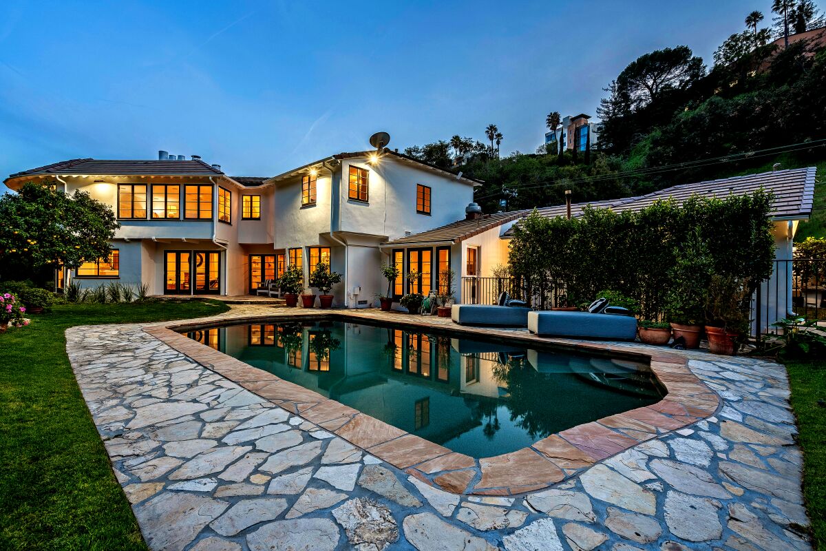 The Georgian-style two-story sits on a double lot with a tennis court and a swimming pool.