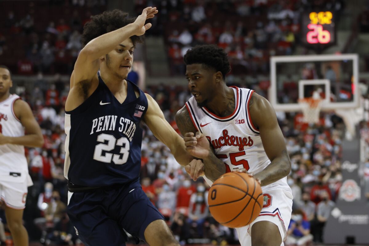 Ohio State's Jamari Wheeler, right, brings the ball up court as Penn State's Dallion Johnson defends during the second half of an NCAA college basketball game Sunday, Jan. 16, 2022, in Columbus, Ohio. (AP Photo/Jay LaPrete)