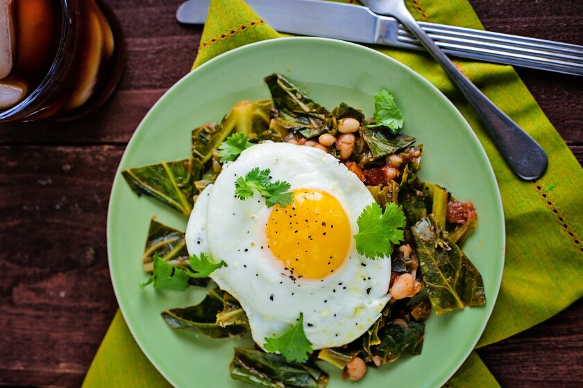 Enjoy this Cilantro & Tomato Simmered Collard Greens with Sunny-Side-Up Egg dish at any time of day.