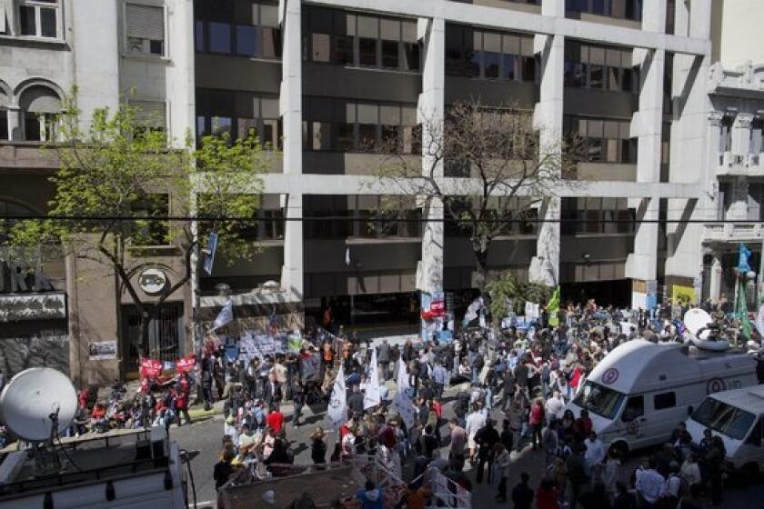 Supporters of Argentina's President Cristina Fernandez gather outside the hospital in Buenos Aires where she underwent surgery Tuesday to remove blood that had collected outside her brain.