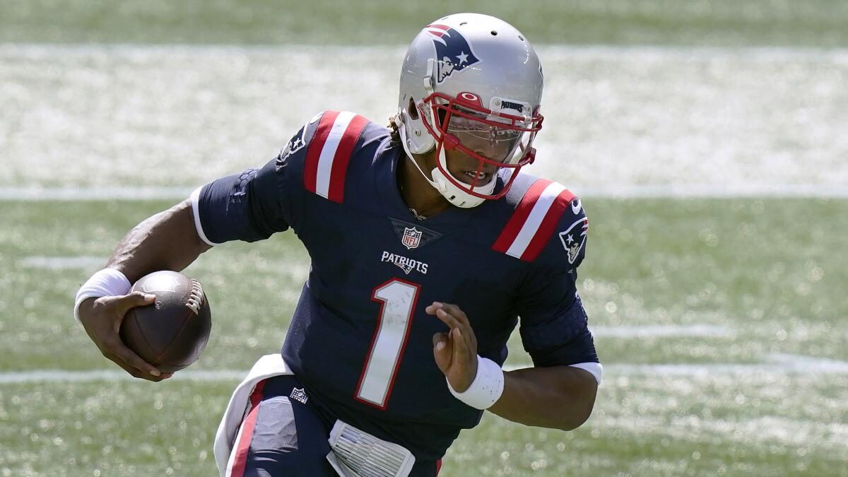 New England Patriots quarterback Cam Newton runs for a touchdown against the Miami Dolphins.