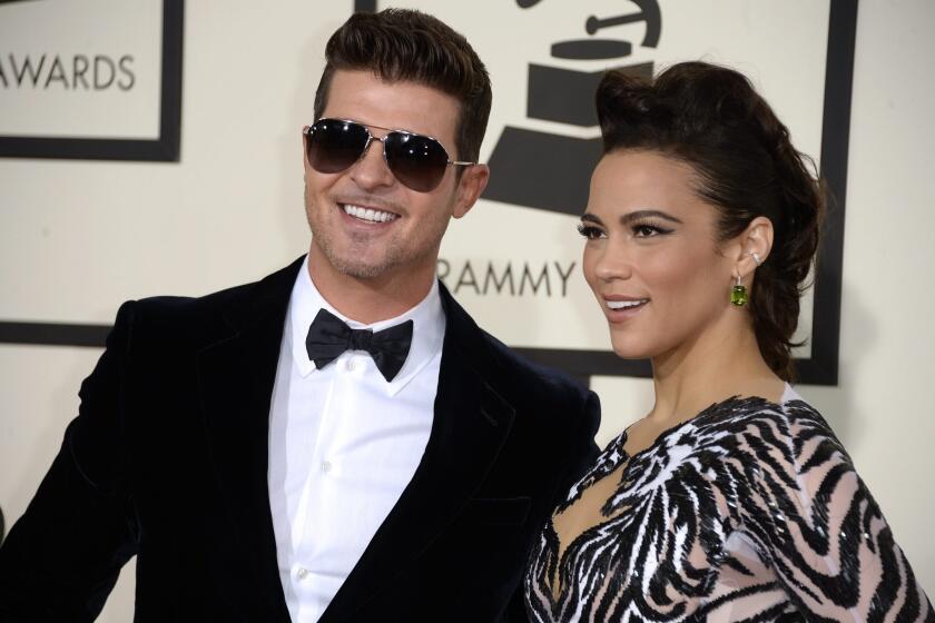 Robin Thicke and Paula Patton, seen at the 56th annual Grammy Awards in Los Angeles, announced the end of their marriage on Monday.