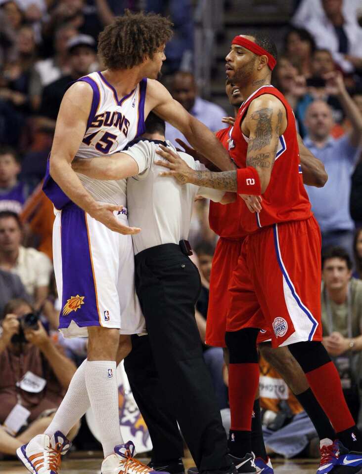 Referee Kane Fitzgerald separates Suns center Robin Lopez and Clippers power forward Kenyon Martin after Lopez committed a flagrant foul against Blake Griffin (not pictured) in the second half Thursday night in Phoenix. Lopez was ejected from the game.