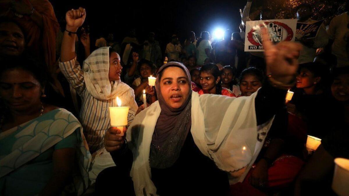 Demonstrators in Bangalore, India, hold a candlelight vigil in memory of an 8-year-old girl whose rape and killing has sparked national outrage.