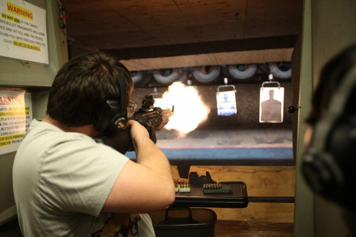 File photo shows a man firing an AK-47 assault rifle at a shooting range.