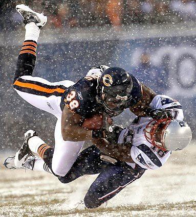 Chicago Bears safety Danieal Manning (38) is tackled by New England Patriots receiver Matt Slater on a kickoff return in the first half of an NFL game in Chicago on Sunday.