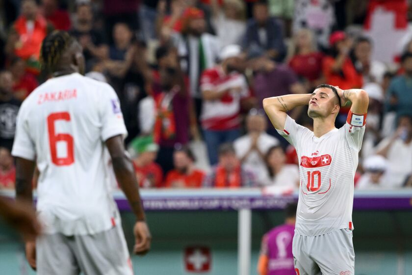 Switzerland's midfielder Granit Xhaka, right, and Switzerland's midfielder Denis Zakaria, left, react after the elimination during the World Cup round of 16 soccer match between Portugal and Switzerland at the Lusail Stadium in Lusail, north of Doha, Qatar, Tuesday, Dec. 6, 2022. (Laurent Gillieron/Keystone via AP)