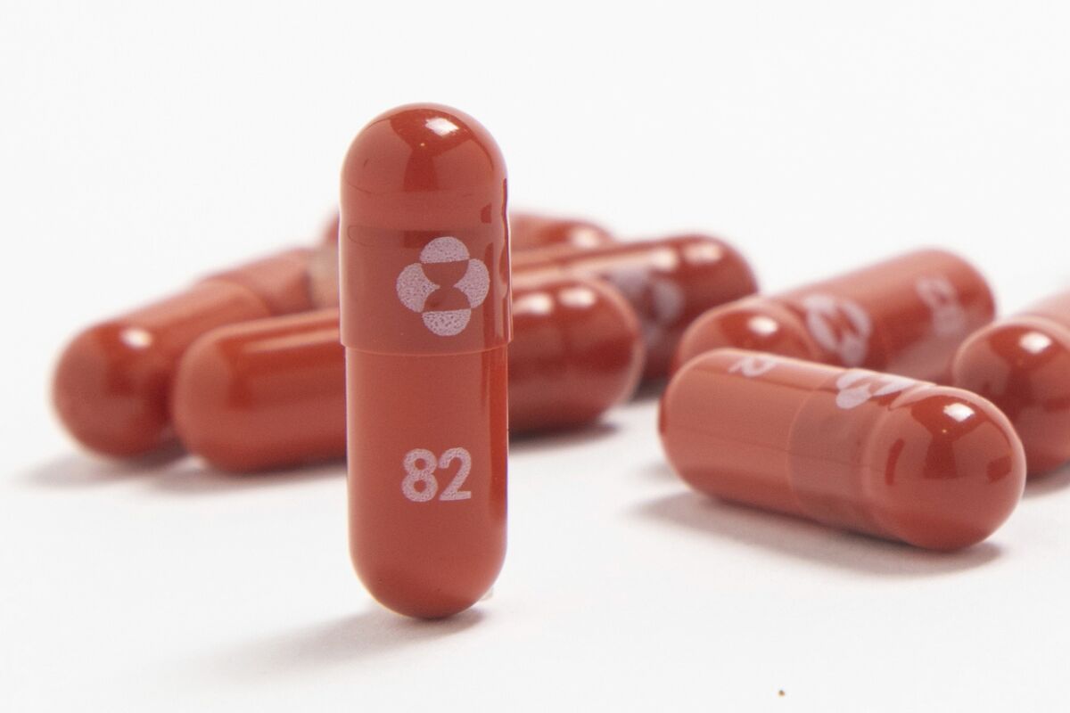 A close-up image of red capsules with a symbol and the number 82 printed on them