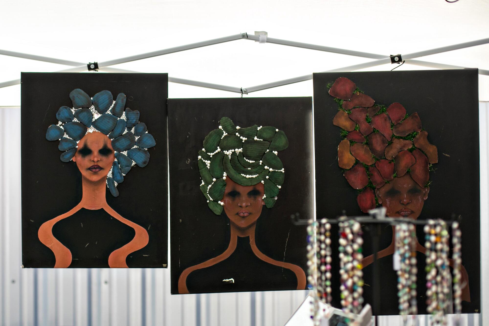 Colorful artworks on display at a Black Market Flea booth