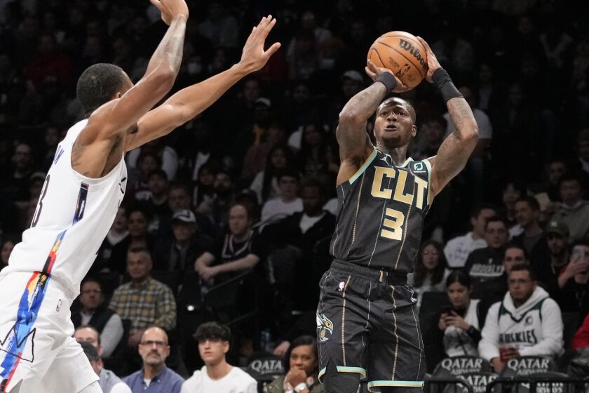 Charlotte Hornets guard Terry Rozier (3) shoots against Brooklyn Nets forward Nic Claxton, left, during the first half of an NBA basketball game, Wednesday, Dec. 7, 2022, in New York. (AP Photo/John Minchillo)