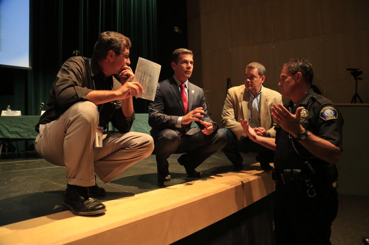 Murrieta Mayor Alan Long, center, holds a meeting last week where more than 700 residents came to get answers about the recent immigration issue.