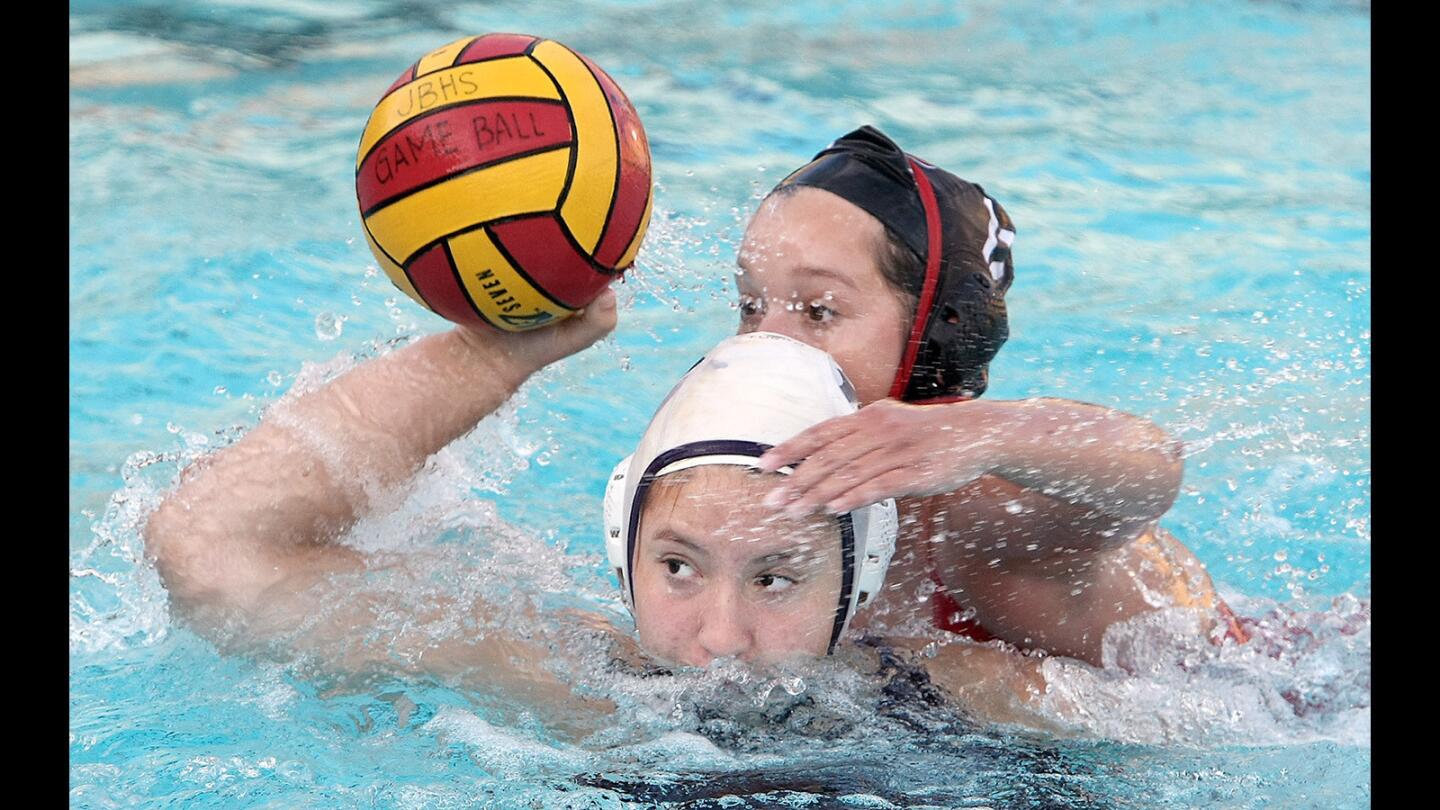 Crescenta Valley's Zoe Huerta lines up a shot as Burroughs' Cameron Flores defends during a game on Thursday, Jan. 28, 2016.