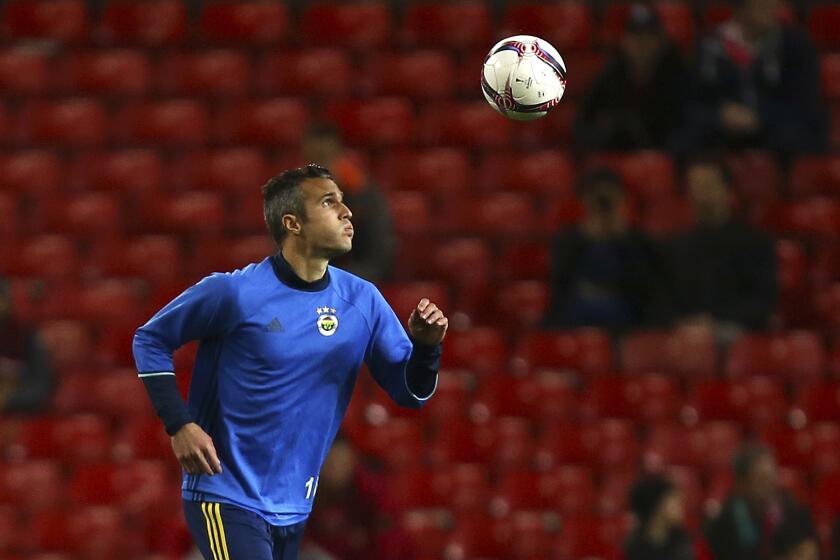 FILE- Robin van Persie warms up ahead of the Europa League Group A soccer match between Manchester United and Fenerbahce at Old Trafford stadium in Manchester, England, Thursday Oct. 20, 2016. Former Arsenal striker Robin van Persie has landed his first topflight head coaching job. He was hired by Dutch club Heerenveen. The 40-year-old Van Persie is the Netherlands men’s team all-time top scorer. (AP Photo/Dave Thompson, File)