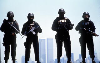 A masked FBI SWAT team poses for a photo.