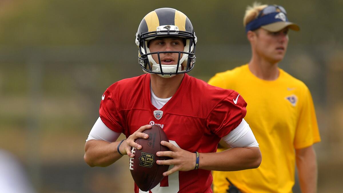 Rams rookie quarterback Jared Goff rolls out to make a pass during a workout Tuesday in Oxnard.