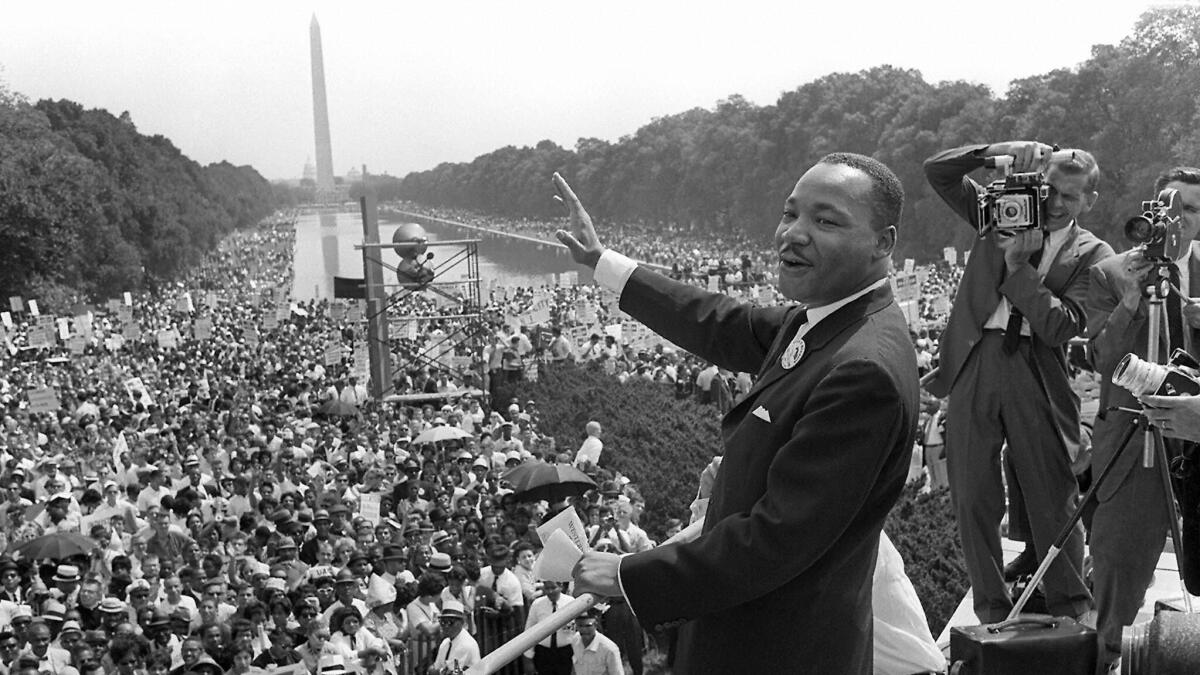 Civil rights leader Martin Luther King Jr. waves to supporters from the Lincoln Memorial during the March on Washington on Aug. 28, 1963.