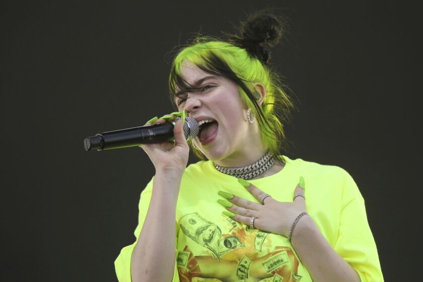 FILE - In this Oct. 5, 2019 photo, Billie Eilish performs during the first weekend of the Austin City Limits Music Festival in Zilker Park in Austin, Texas. Eilish will perform at this month's Grammy Awards. (Photo by Jack Plunkett/Invision/AP, File)