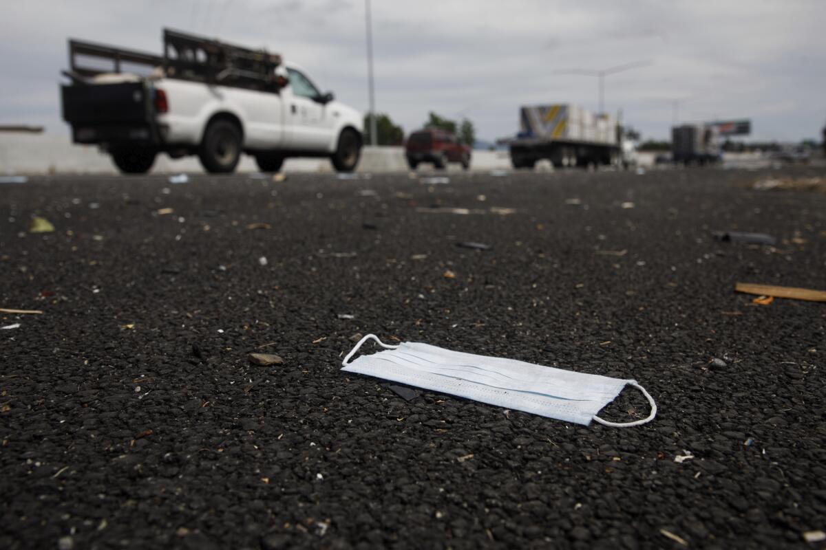 One of the spilled masks is visible on the shoulder of southbound Interstate 880 in Union City. In the midst of the coronavirus pandemic, the freeway suffered a mini-traffic jam when someone tossed hundreds of face masks onto the road and some motorists stopped to grab them, the California Highway Patrol reported.