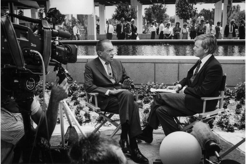 July 19, 1990: Camera's roll as former Presidenttnt Richard Nixon is interviewed by NBC's Tom Brokaw by the reflecting pool at the Nixon Library. The Nixon Library was being dedicated. This photo appeared in the July 20, 1990, Los Angeles Times.